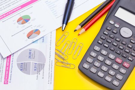 Papers, glasses and calculator to make calculations of the invoices we receive, to make graphs and statistics of our expenses or benefits. scientific calculator used by science studentsの写真素材