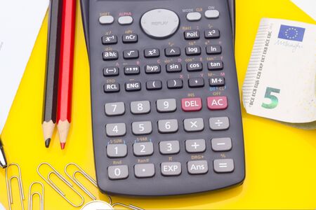 Papers, glasses and calculator to make calculations of the invoices we receive, to make graphs and statistics of our expenses or benefits. scientific calculator used by science studentsの写真素材