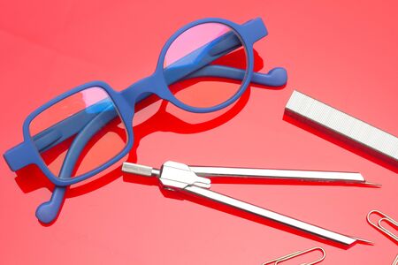 Diverse office supplies, clips, pencils, pen, staples, stapler, money, coins, compass; professional office or high school or university student office.の写真素材