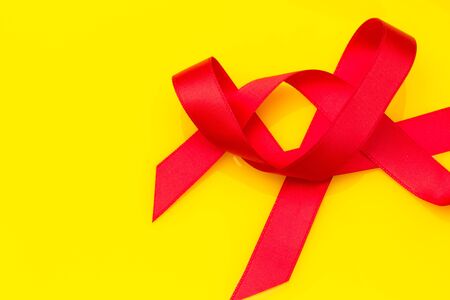 Red bow on yellow backgroundの写真素材