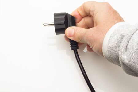 Cable with electric plug ready to plug into the electric current and make some device work; plug in...