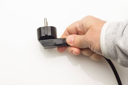 Cable with electric plug ready to plug into the electric current and make some device work; plug in...
