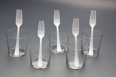 Forks of white color and constructed with recyclable plastic material, to prick Picnic food among...