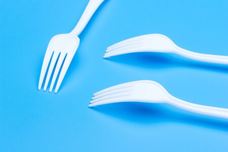 plastic tableware for picnics, parties and informal meals. White plastic disposable holders for use...