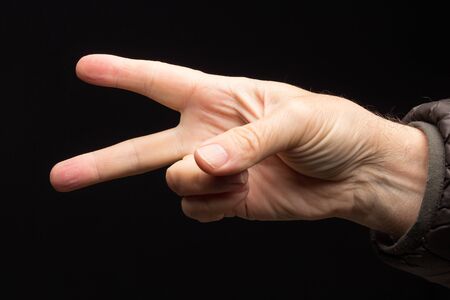 finger signals, non-verbal language, symbols and signals, hand conversation. Numbers made with the fingers of one hand. Adult's hand on black background.の写真素材