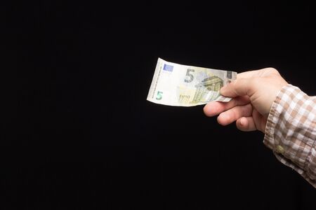 Wad of euro banknotes in the hand of a person, prepared to buy or to save and enter the bank. Banknotes of legal tender, European currency.の写真素材