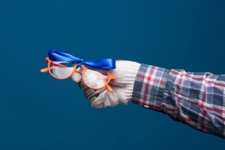Professional hands protected with industrial gloves. Gloves for hand protection. Hands with medicine products, industrial products, glasses, medicine cabinet.の写真素材