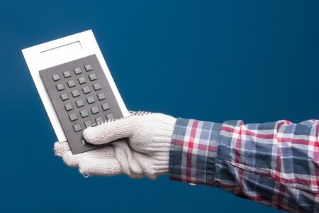 Professional hands protected with industrial gloves. Gloves for hand protection. Hands with medicine products, industrial products, glasses, medicine cabinet.の写真素材