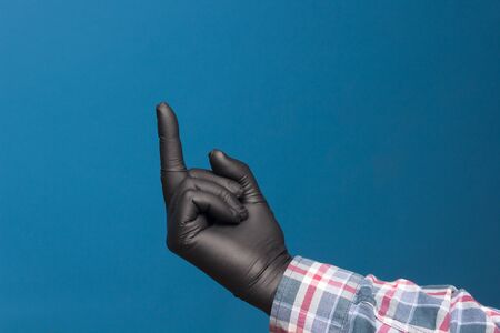 Hygienic hand protection, fine black glove to avoid losing touch in the hands. Hand and finger signs.の写真素材