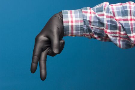 Hygienic hand protection, fine black glove to avoid losing touch in the hands. Hand and finger signs.の写真素材