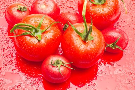 Tomatoes and apples, red fruits, for salads to eat raw, full of vitamins and few calories ideal for dieting.の写真素材