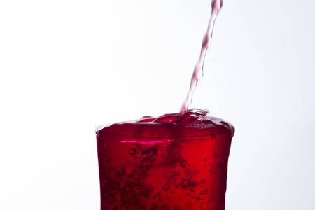 Clear, drinking water falls into a clear glass, healthy, wholesome, fresh water with no odor or taste. Splash of water drops splashing onto the surface. Jet of water entering the glassの写真素材