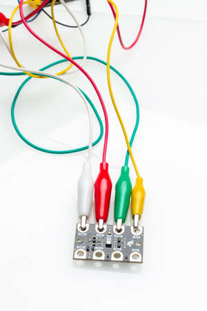 Part with electronic components and electrical cables of different colors that is part of a complex...