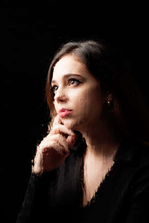 Young, pretty girl, pensive, depressed, melancholic, thinking about her future or her experiences;...