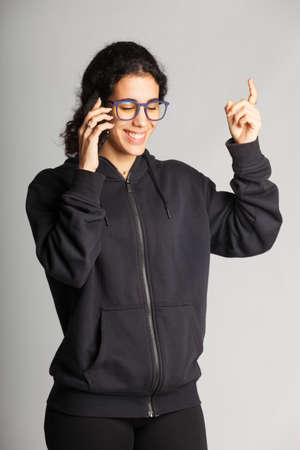Young girl talking on smartphone; Young man communicating with a friend.の写真素材