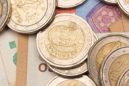 Euro coins and banknotes, close-up of the official currency of Europe. Used and worn coins