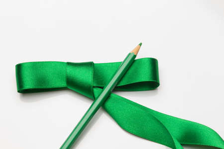 Give colored pencils as gifts. Bouquet of colored pencils surrounded and gift-wrapped with a green ribbon. Ecological colorsの写真素材