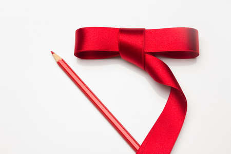 Give colored pencils as gifts. Bouquet of colored pencils surrounded and gift-wrapped with a green...