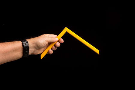 Different colors in the hand showing the camera simple and primary colors, bright colors on a black background.の写真素材