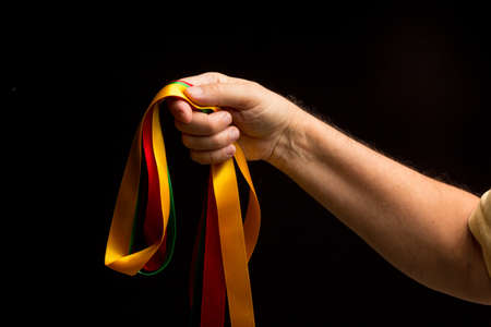 Different colors in the hand showing the camera simple and primary colors, bright colors on a black background.の写真素材