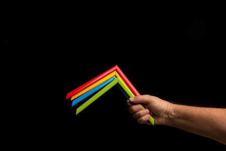 Different colors in the hand showing the camera simple and primary colors, bright colors on a black...