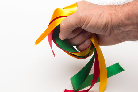 hand with colored ribbon on white background; basic colors on an adult hand of a person.の写真素材