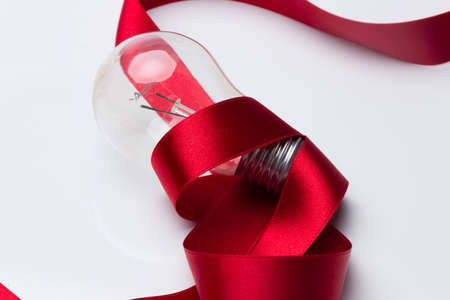 Traditional transparent glass bulb, bulb that works with electric energy, heating the filaments and giving light of a color of about 3500 degrees kelving. Incandescent bulbの写真素材