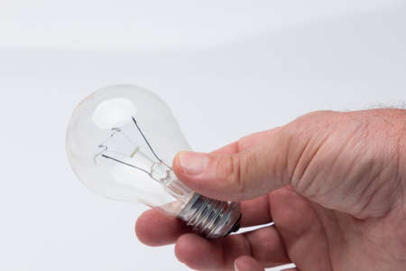 Traditional transparent glass bulb, bulb that works with electric energy, heating the filaments and giving light of a color of about 3500 degrees kelving. Incandescent bulbの写真素材