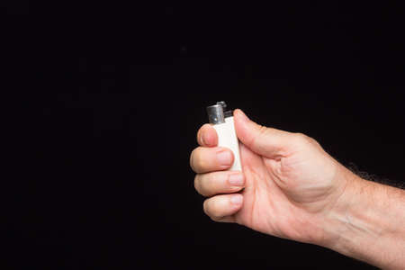 White lighter in the palm of an adult's handの写真素材