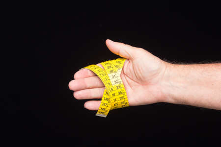 Tailor's and dressmaker's tape measure, flexible, yellow, for measuring parts of the human body to create suits and dresses.の写真素材