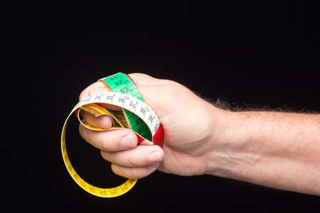 Tailor's and dressmaker's tape measure, flexible, yellow, for measuring parts of the human body to create suits and dresses.の写真素材