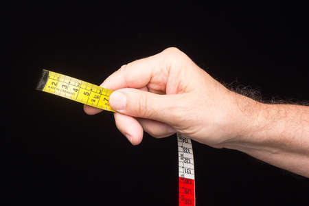 Tailor's and dressmaker's tape measure, flexible, yellow, for measuring parts of the human body to create suits and dresses.の写真素材
