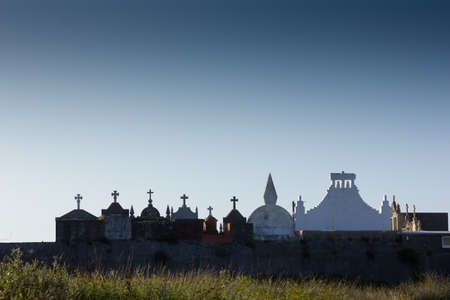 Silhouettes at sunset of crosses in a cemetery in Galicia, Spain. Crosses and symbology in a cemetery.の写真素材