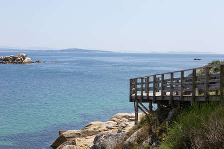 Rustic wooden path near the sea on a sunny day. Dark wood.の写真素材