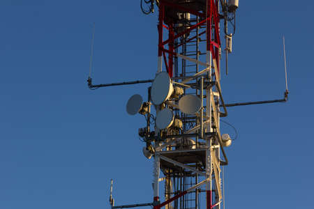 Multicolored telecommunications antenna on top of a mountain. Modern digital communicationの写真素材