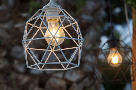 Decorative filament bulb on a terrace at duskの写真素材