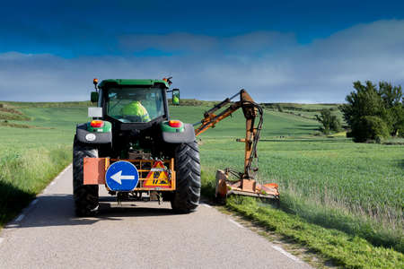 Machine removing weeds on a secondary road in central Spain in springtimeの写真素材