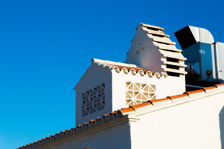 white chimney and white smoke outlet in white houseの写真素材