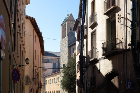 Traditional buildings with ornate facades under the clear blue sky in Vic, Spain