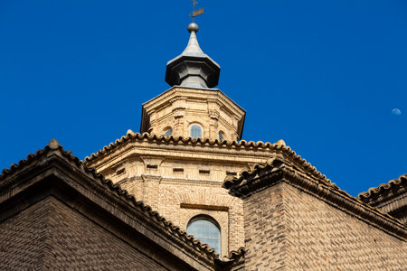 Historic bell tower of San Juan de los Panetes church against a clear blue sky in Zaragoza, Spainの写真素材