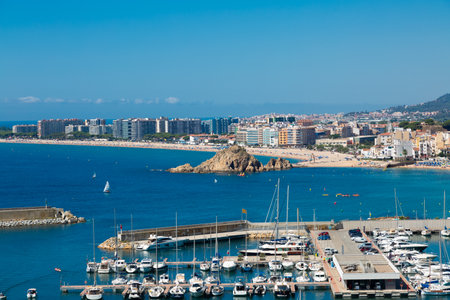 Aerial view of blanes cityscape with harbor, beach, sa palomera rock, hotels and residential buildings in summertimeの写真素材