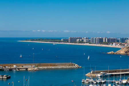 Aerial view of blanes cityscape with harbor, beach, sa palomera rock, hotels and residential buildings in summertimeの写真素材