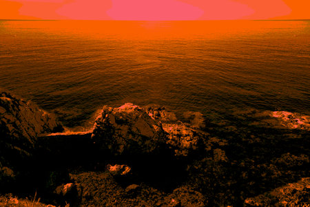 Boats sailing in the distance on beautiful turquoise water with rocky cliffs in the foregroundの写真素材