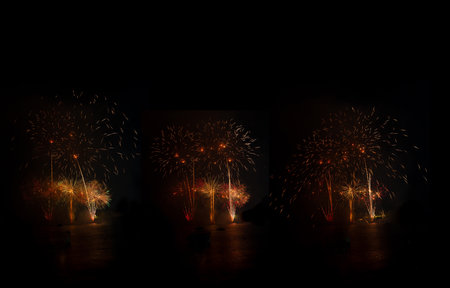 Bright fireworks exploding over boats on the water illuminating the night skyの写真素材