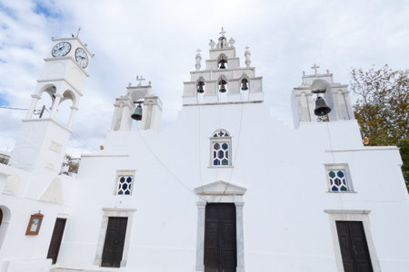 Traditional greek orthodox church building with whitewashed walls and bell tower, showcasing greek island architectureの写真素材