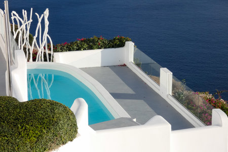 White painted houses and blue domed churches creating a picturesque cityscape in Oia, Santorini, Greeceの写真素材
