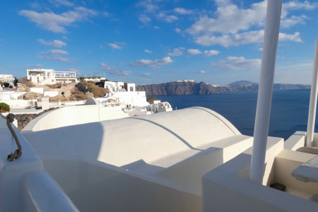 White painted houses and blue domed churches creating a picturesque cityscape in Oia, Santorini, Greeceの写真素材