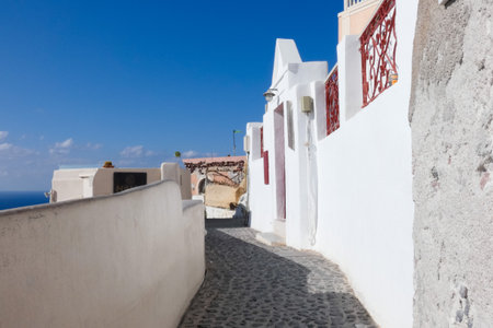 White painted houses and blue domed churches creating a picturesque cityscape in Oia, Santorini, Greeceの写真素材