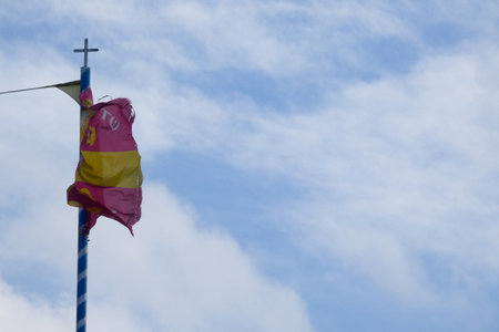 Flag with cross and eagle design fluttering in the breezeの写真素材