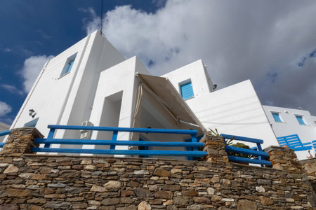 Local man walking away on a narrow cobblestone street in Paros town, Greeceの写真素材